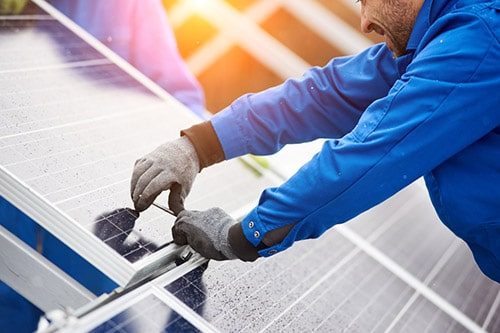 Man Installing Solar Panels — Electricians in Maroochydore, QLD