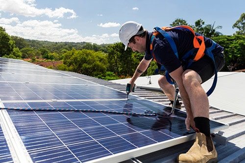 Solar Panel Technician Installing Solar Panels — Electricians in Sunshine Coast, QLD