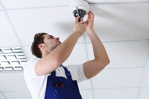 Technician Installing CCTV Camera — Electricians in Caloundra, QLD